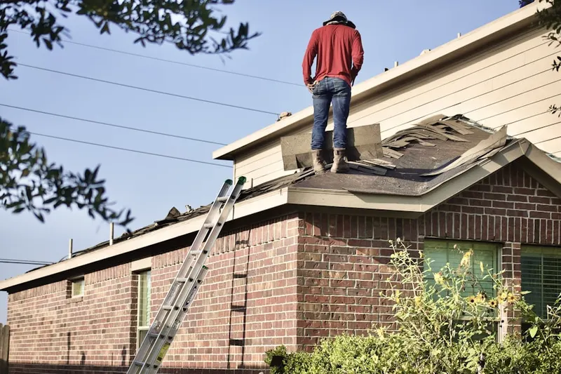 Professional roofer working on a residential roof in East Lake Landings